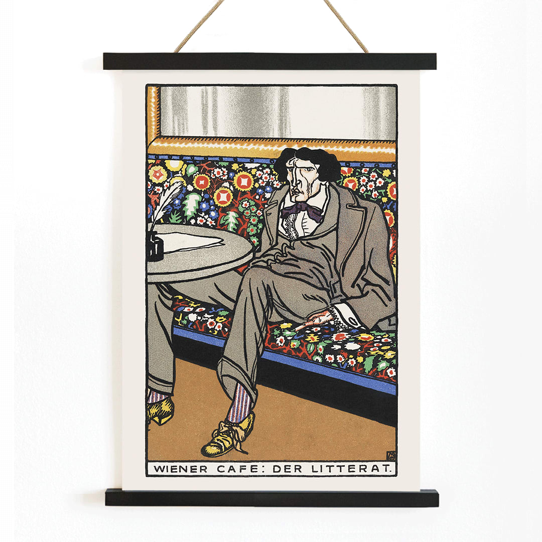 Poster of a man lounging in an ornate Viennese café setting on a floral bench at a table titled Viennese Café The Man of Letters by Moriz Jung, with wooden magnetic frame on white background