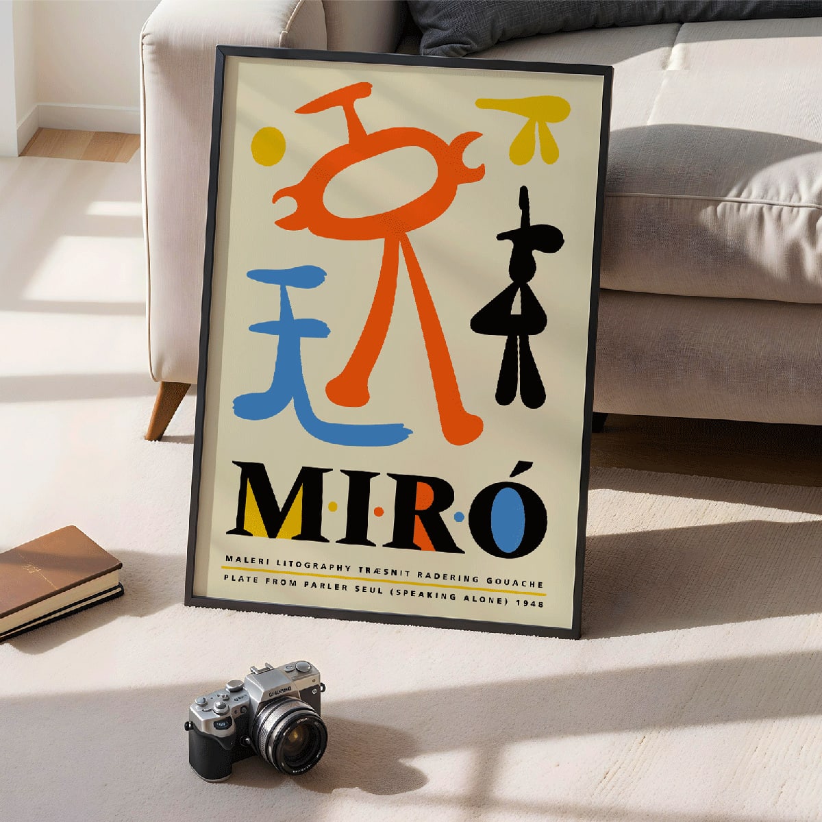 Exhibition poster inspired by Joan Miro and artwork Parler Seul featuring colorful abstract shapes and bold typography, framed and displayed in modern living room decor