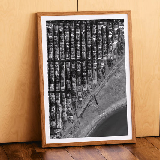 Aerial cityscape and black and white poster of Barceloneta beach and city grid aerial view, framed and displayed in home decor
