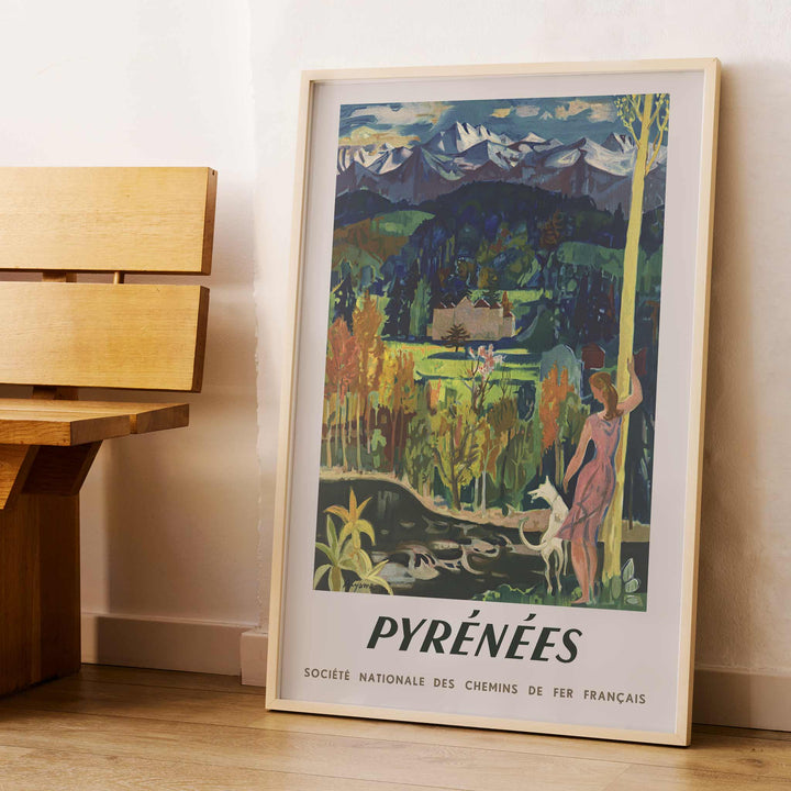 Pyrenees Railway poster by Roger Aujame with alpine peaks, green valley, blue skies, and woman by stream, with wooden magnetic frame on white background