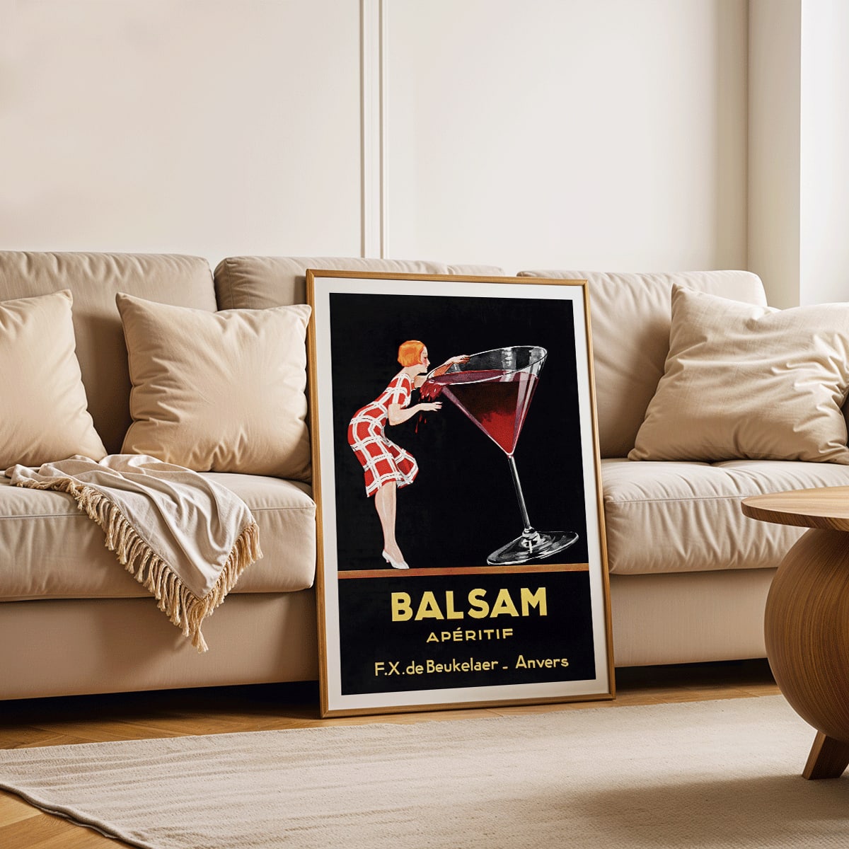 Balsam Aperitif poster by Jean d Ylen showing a woman sipping from a giant red cocktail glass vibrant vintage art, framed and displayed in modern living room decor
