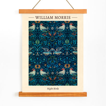 Night Birds by William Morris colorful patterned illustration and poster with intricate birds and floral designs in rich blue and green tones, with wooden magnetic frame on white background