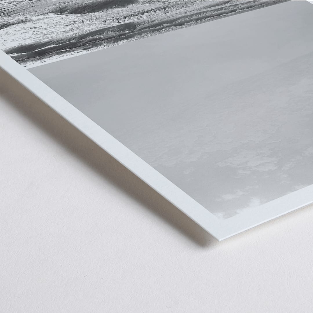 Closeup detail of Black and white poster of a surfer with a board entering the ocean titled Surfer in Portugal by artist Black