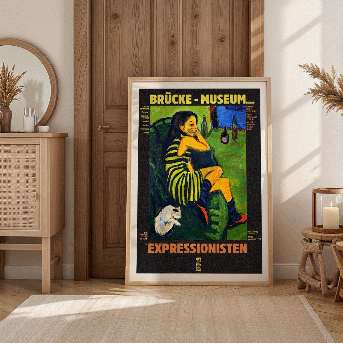 Brucke museum exhibition poster of Female Artist by Ernst Ludwig Kirchner showing a colorful expressionist scene, framed and displayed in modern living room decor