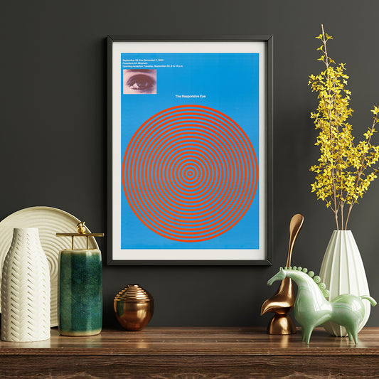 Op art poster with blue and red concentric circles and eye detail from The Responsive Eye by Patrick Blackwell, framed and displayed in home decor