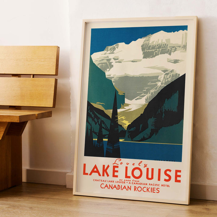Lovely Lake Louise Canadian Pacific poster with snowy Canadian Rockies, pine trees and blue alpine lake in Canada, framed and displayed in modern living room decor