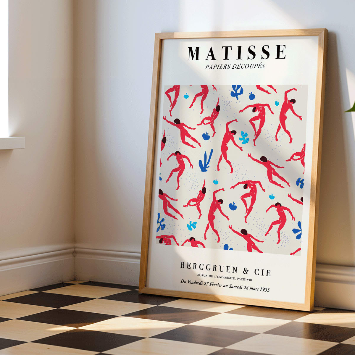 Henri Matisse Dancing Figures Exhibition Poster with vibrant red and blue design featuring red cut out figures on a patterned background with exhibition details, framed and displayed in home decor