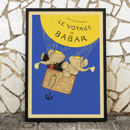 Le Voyage de Babar by Jean de Brunhoff illustration and poster featuring elephants in a hot air balloon with a yellow balloon on a blue background, framed and displayed in modern living room decor