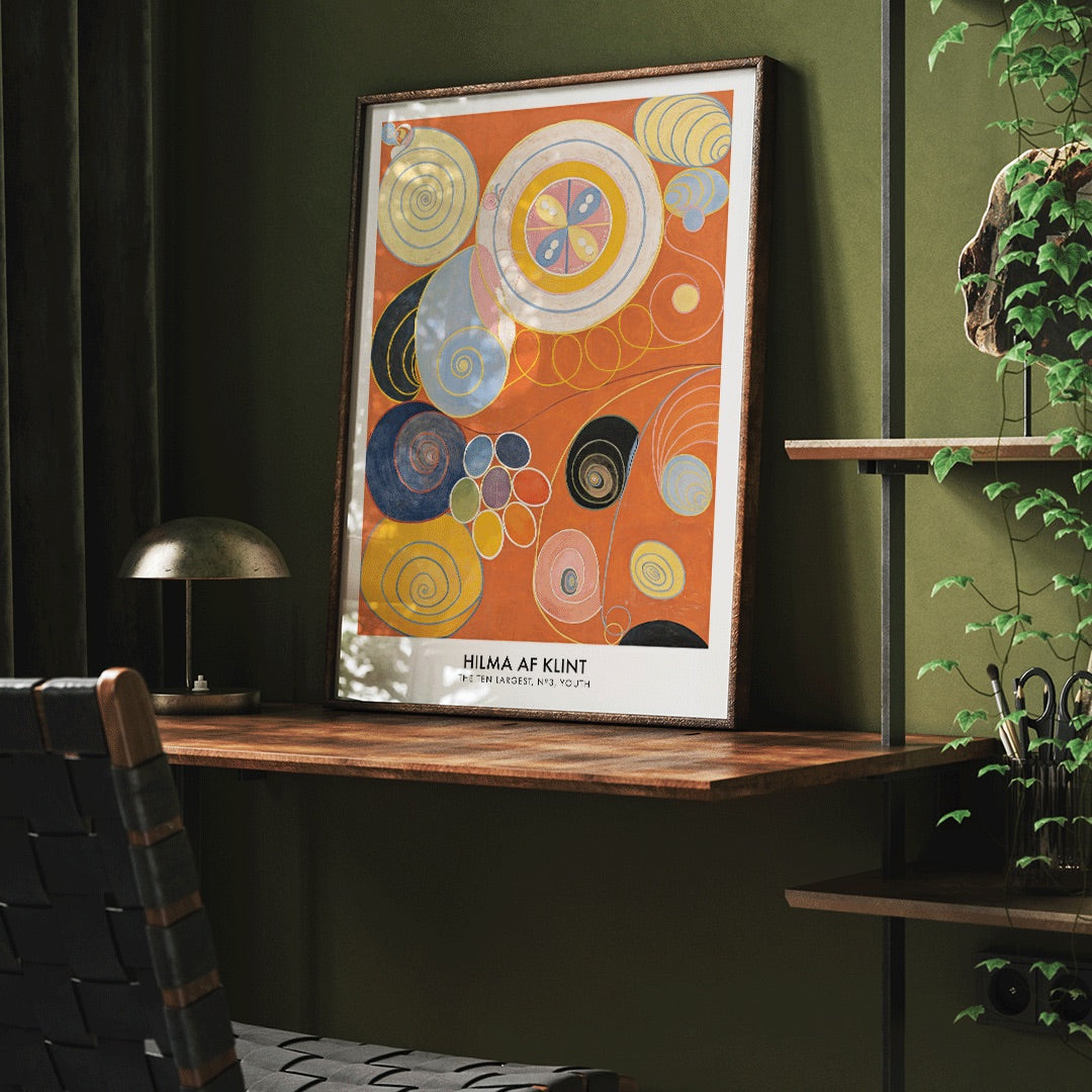 Abstract colorful spirals and organic shapes on vibrant orange background from The Ten Largest Youth by Hilma af Klint, framed and displayed in modern living room decor
