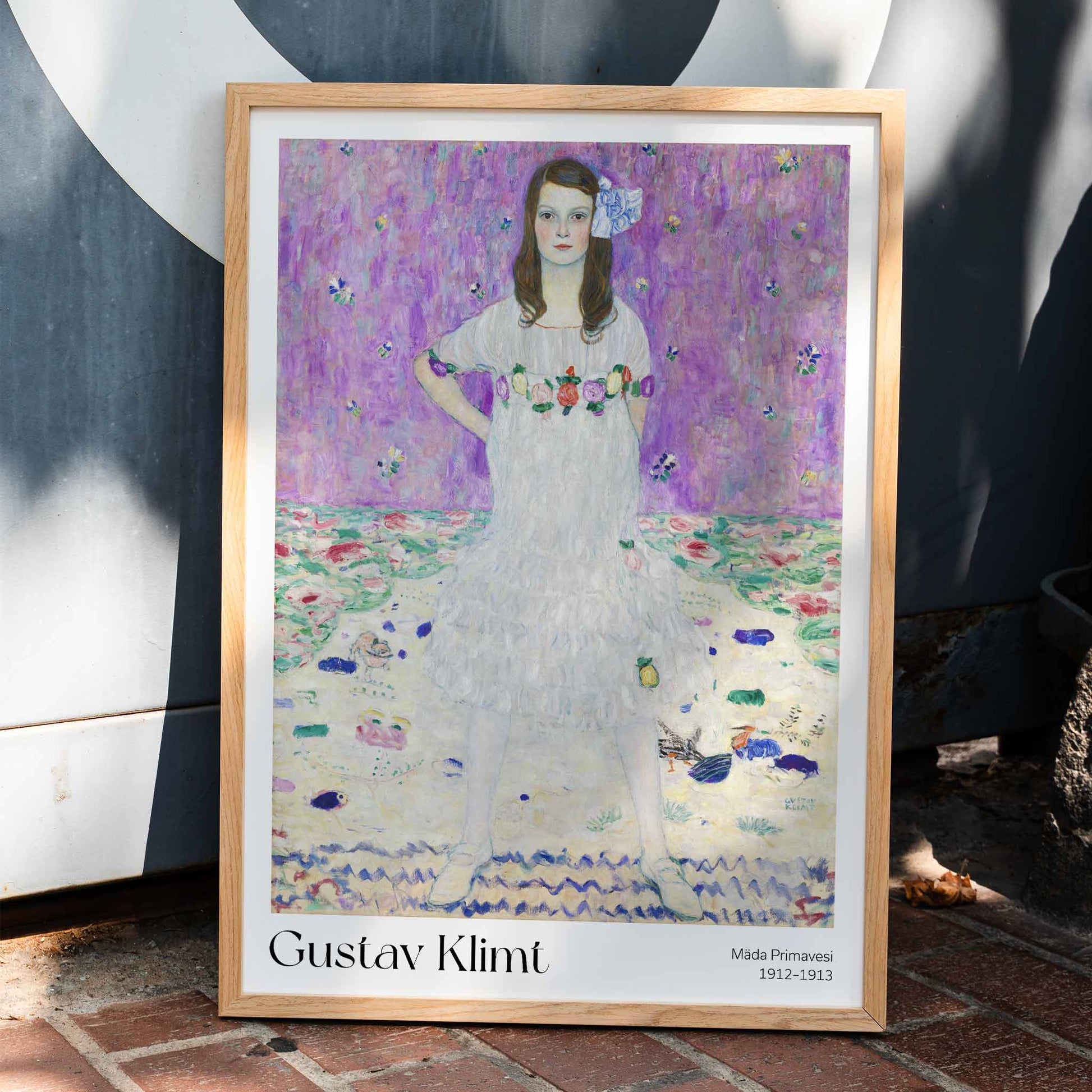 Mada Primavesi by Gustav Klimt poster featuring a young girl in a white dress with a colorful floral background, framed and displayed in home decor