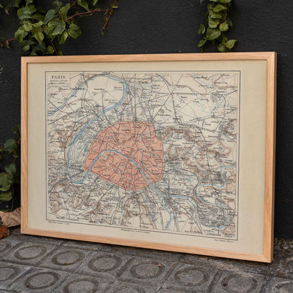 Ancient map of Paris city and surroundings by Bibliographic institute of Liepzig with detailed streets and highlighted city center poster artwork, framed and displayed in home decor