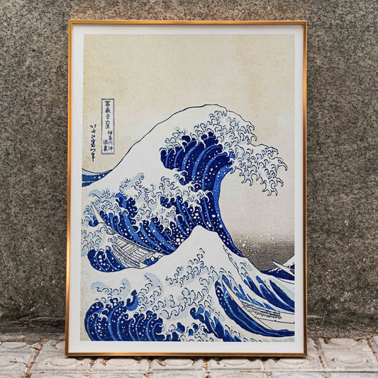The Great Wave off Kanagawa by Katsushika Hokusai showing a dramatic large wave threatening small boats with Mount Fuji in the background, framed and displayed in home decor
