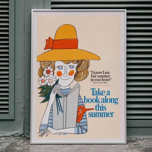 Poster by Bill Sokol showing a woman in a yellow hat holding a book and flowers with Take a Book Along This Summer text, framed and displayed in home decor