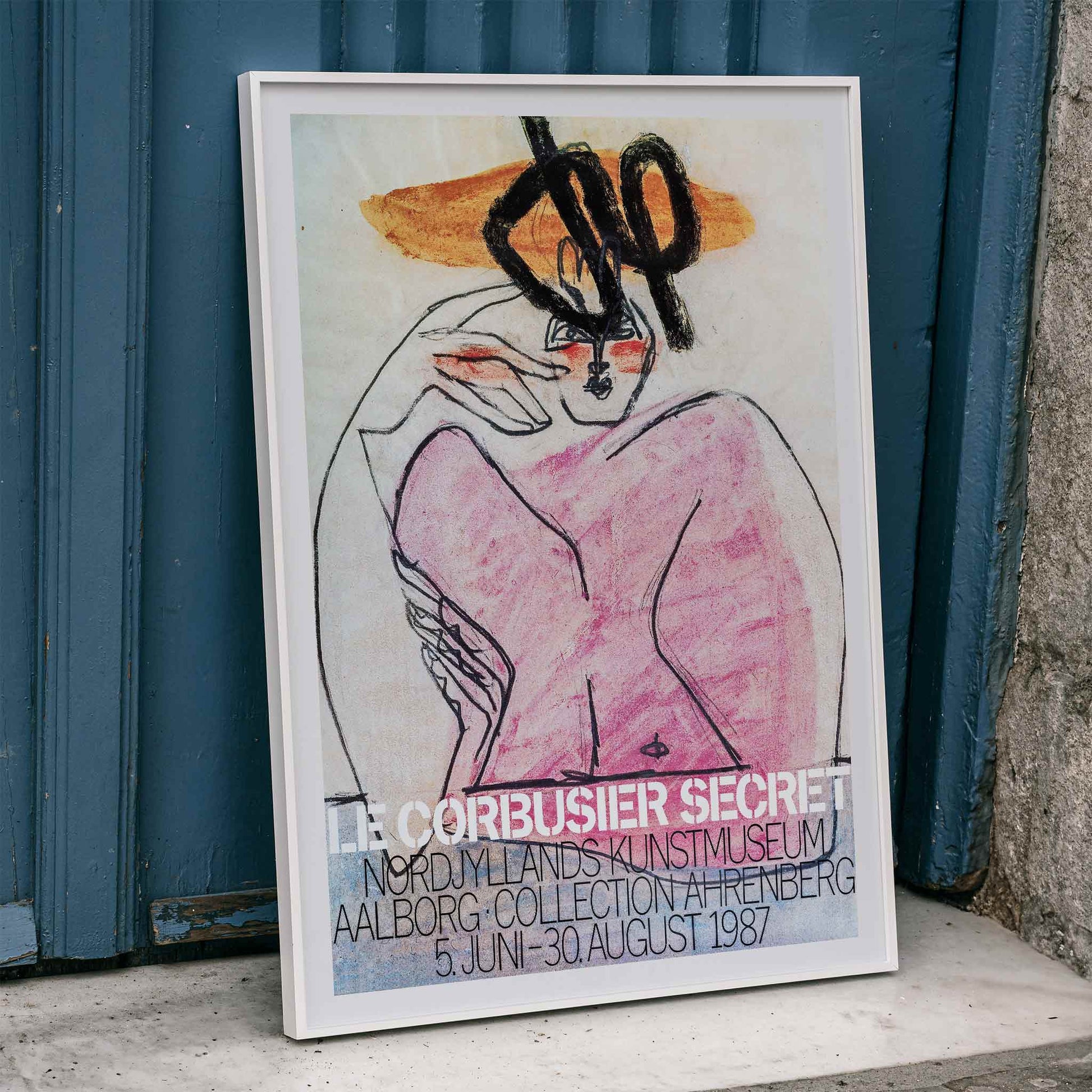 Secret Ahrenberg Collection Exhibition poster by Le Corbusier featuring abstract art with bold lines and vivid colors, framed and displayed in home decor
