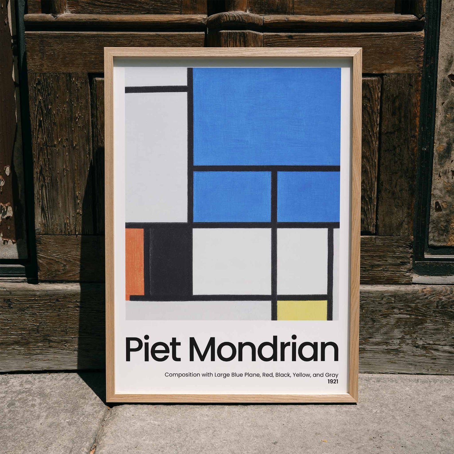 Abstract geometric painting and poster featuring Composition with Large Blue Plane Red Black Yellow and Gray by Piet Mondrian, framed and displayed in home decor