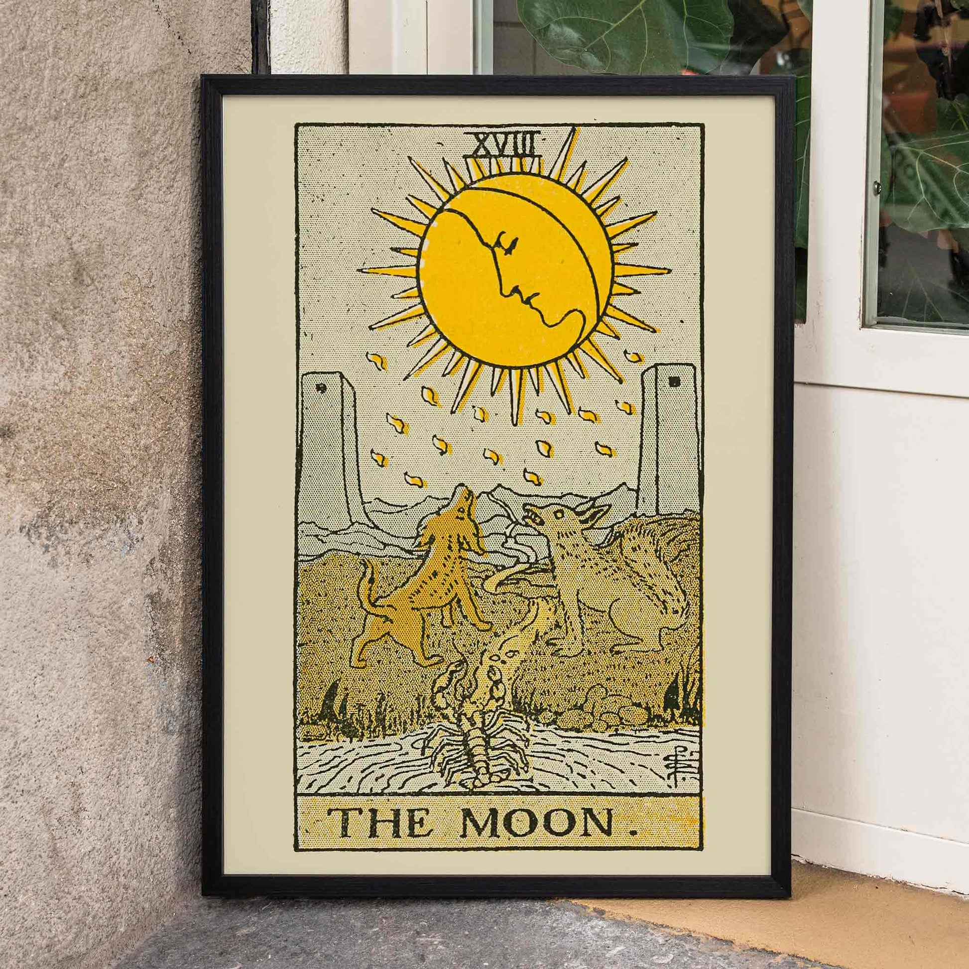 The Moon tarot card by Lauron William de Laurence featuring sun animals and dogs howling at a moon with a face, framed and displayed in home decor