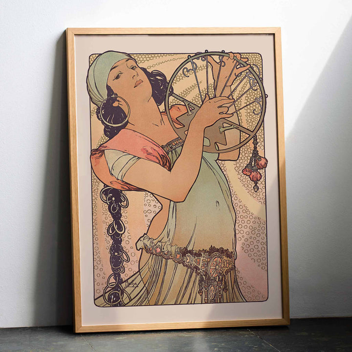 Alphonse Mucha Salome Art Nouveau poster elegant woman holding decorated circular motif in soft peach beige and green tones, framed and displayed in modern living room decor