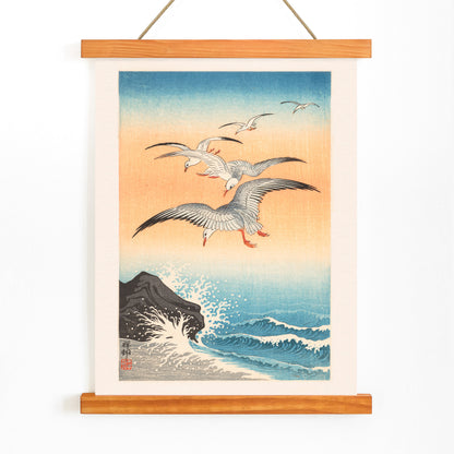 Five seagulls flying over turbulent sea with waves and rocky shore artwork by Ohara Koson, with wooden magnetic frame on white background