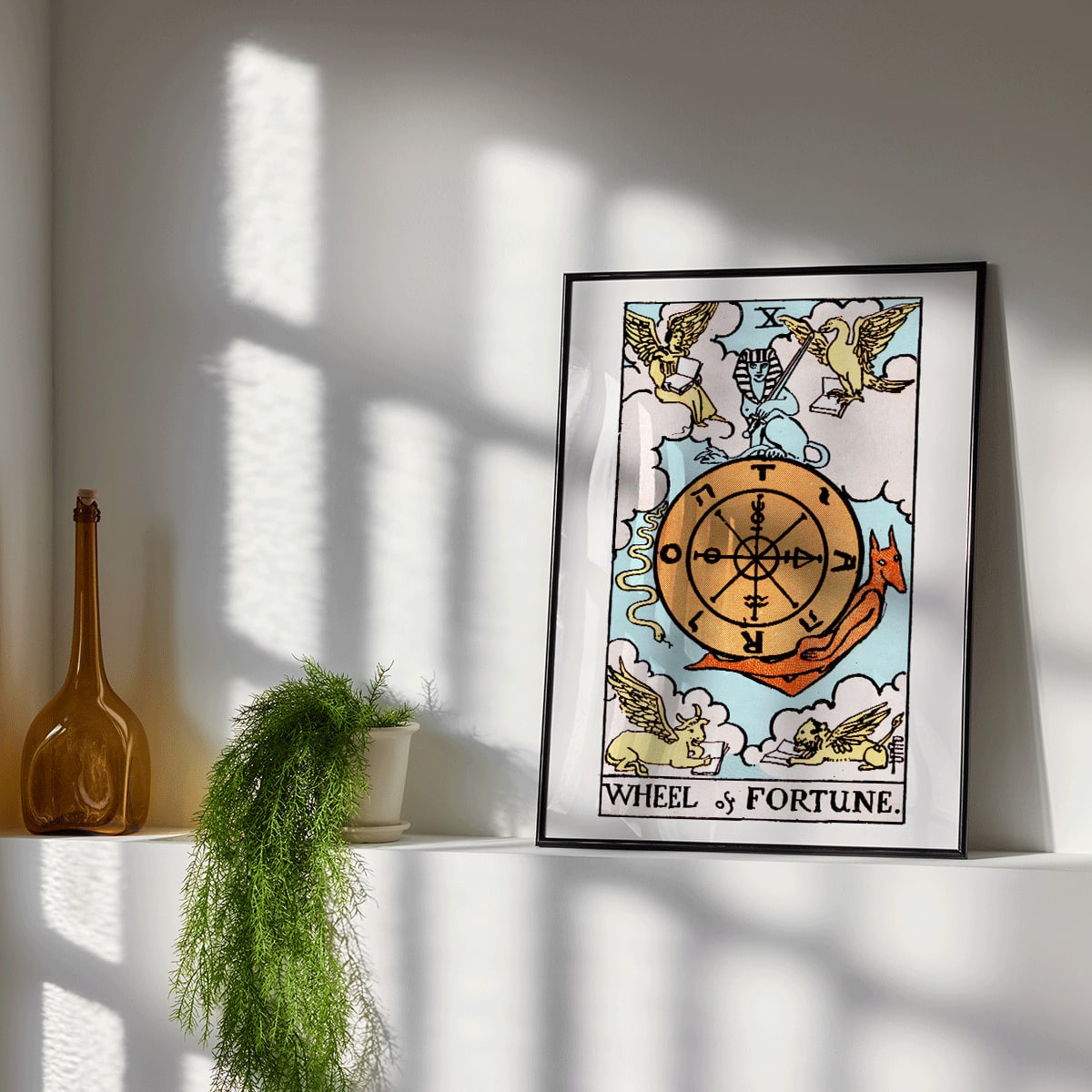 Tarot The Wheel Of Fortune by Rider Waite featuring a mystical wheel surrounded by mythical creatures poster and card artwork, framed and displayed in modern living room decor